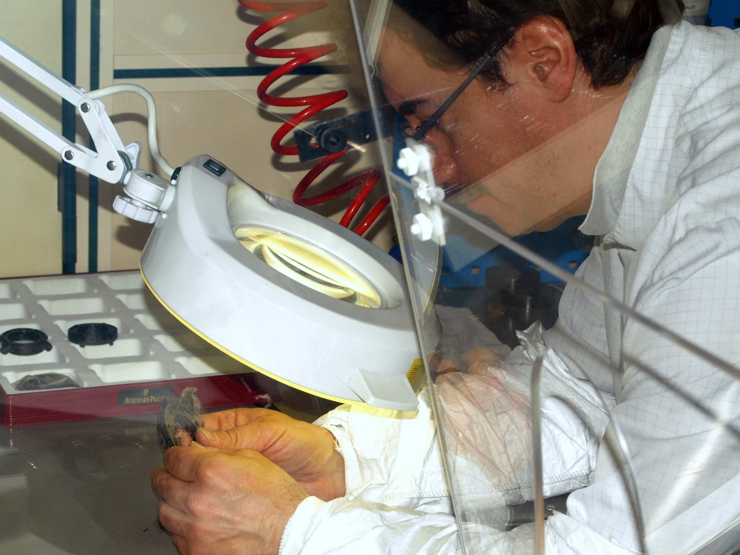 Technician verifying consistency of forged carbon case